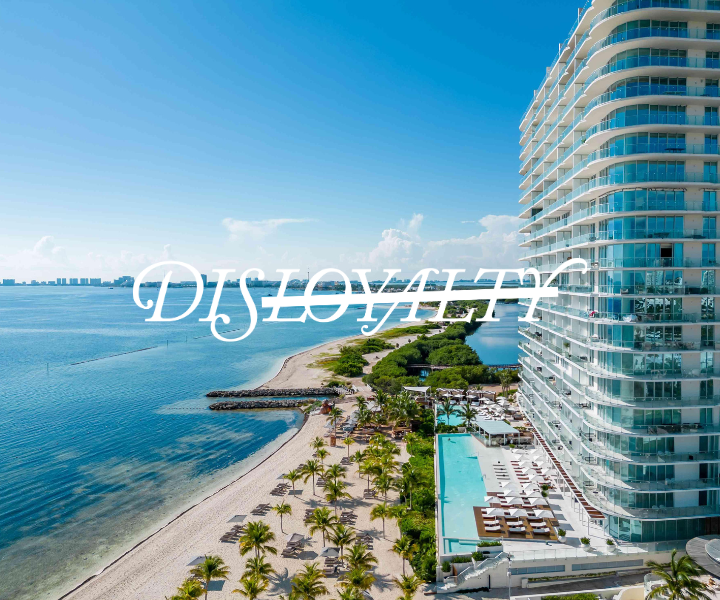 a beautifully designed tower hotel overlooking a pool and beach with the disloyalty logo overlaying the image