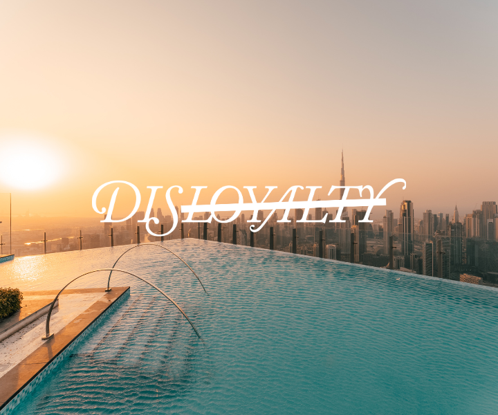 a beautiful infinity pool at golden hour with the disloyalty logo
