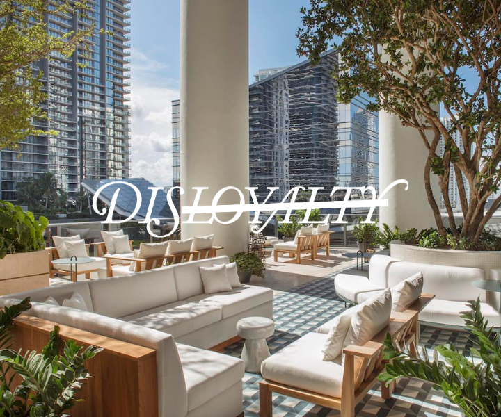 a luxurious patio filled with furniture and views of the brickell skyline with the disloyalty logo overlayed on the image