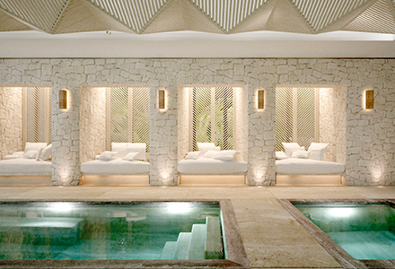 a tranquil spa with two pools and large lounge spaces