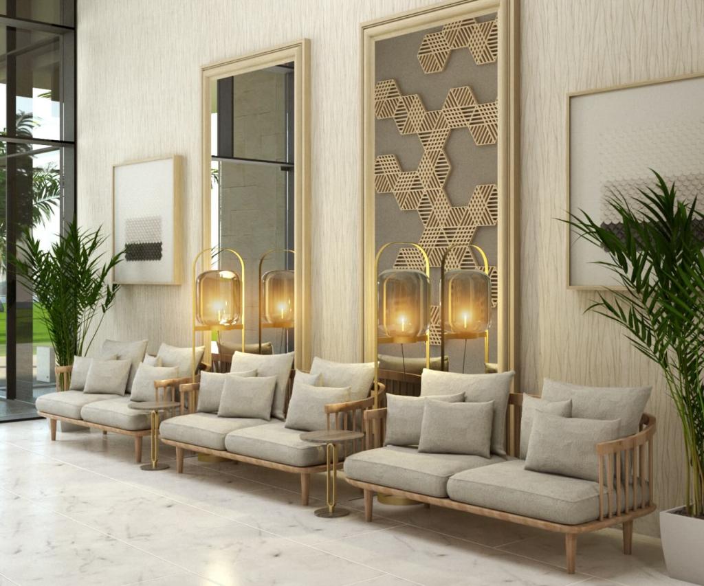 a ballroom foyer with comfortable seating and tall potted plants