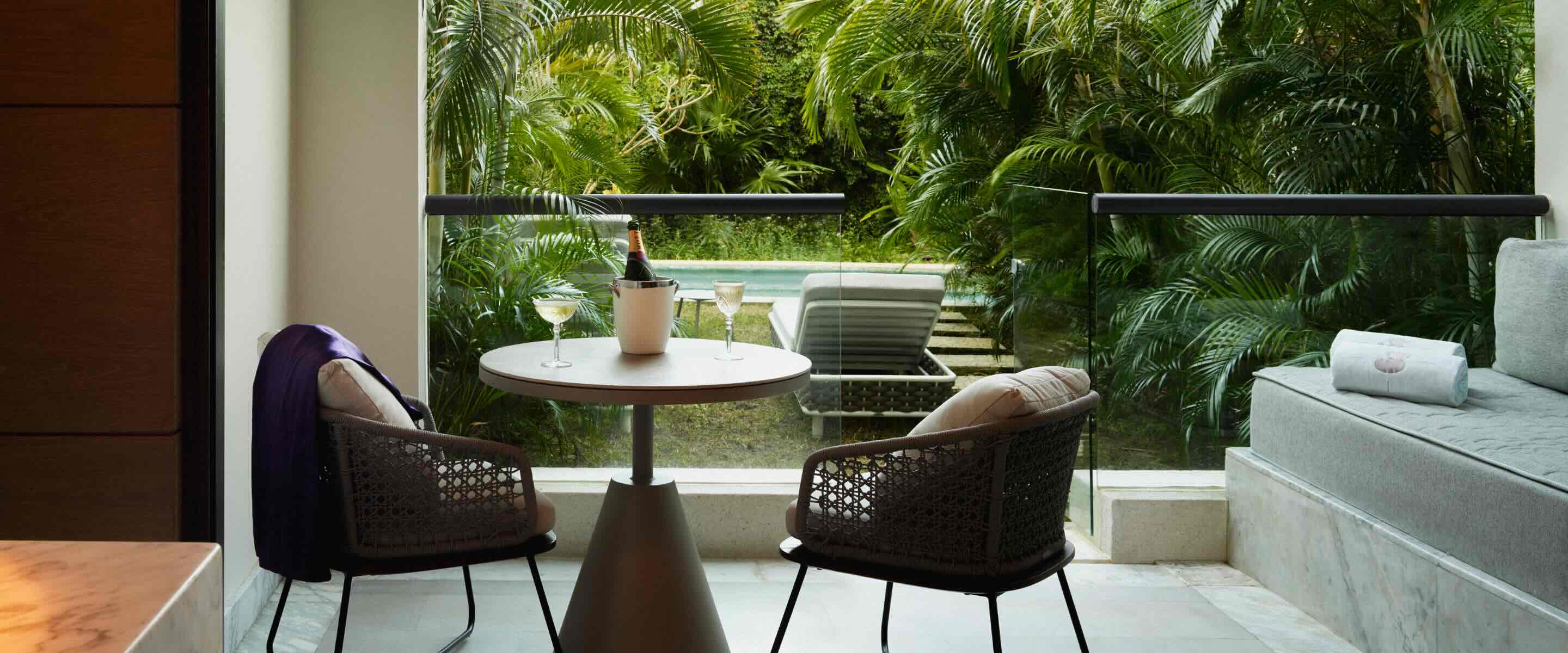 a captivating living room with a kitchen table overlooking the swim-out access pool