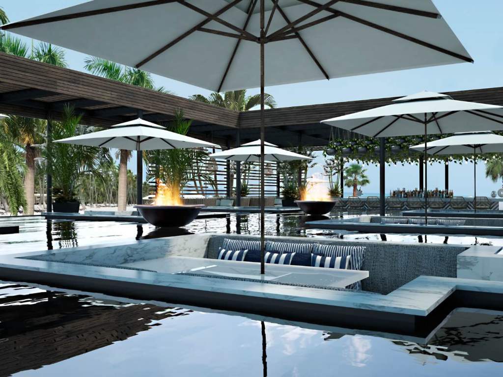 an outdoor pool area with comfortable seating, fireplaces and umbrellas