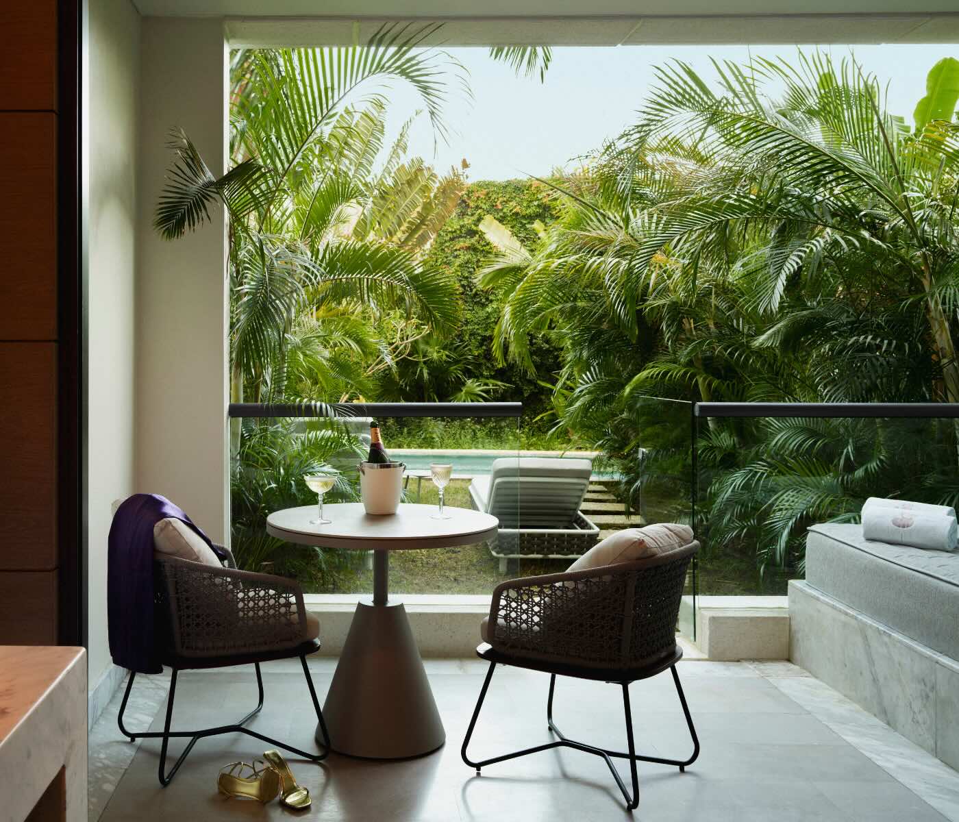 a captivating living room with a kitchen table overlooking the swim-out access pool