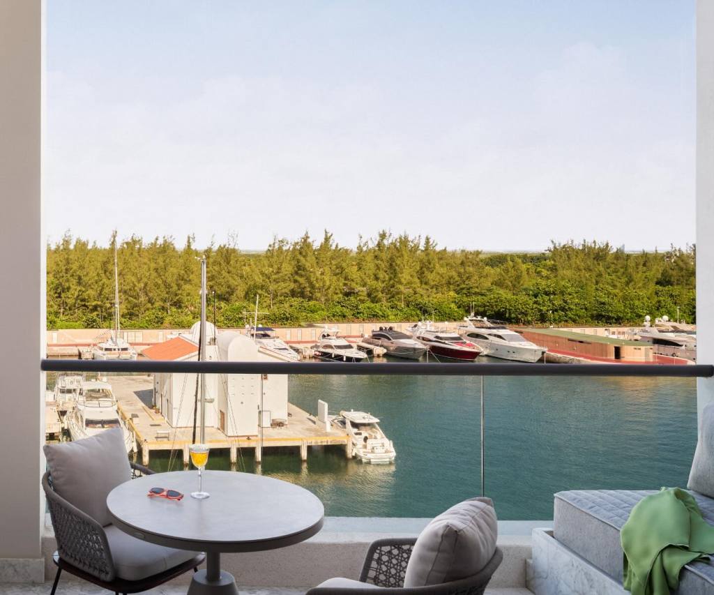 two chairs on a terrace overlooking the marina with boats in the water