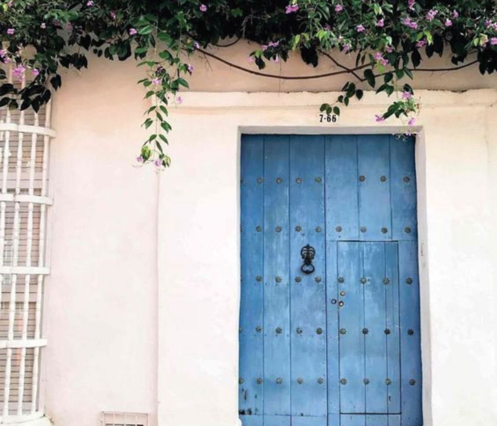 a blue door at a white building