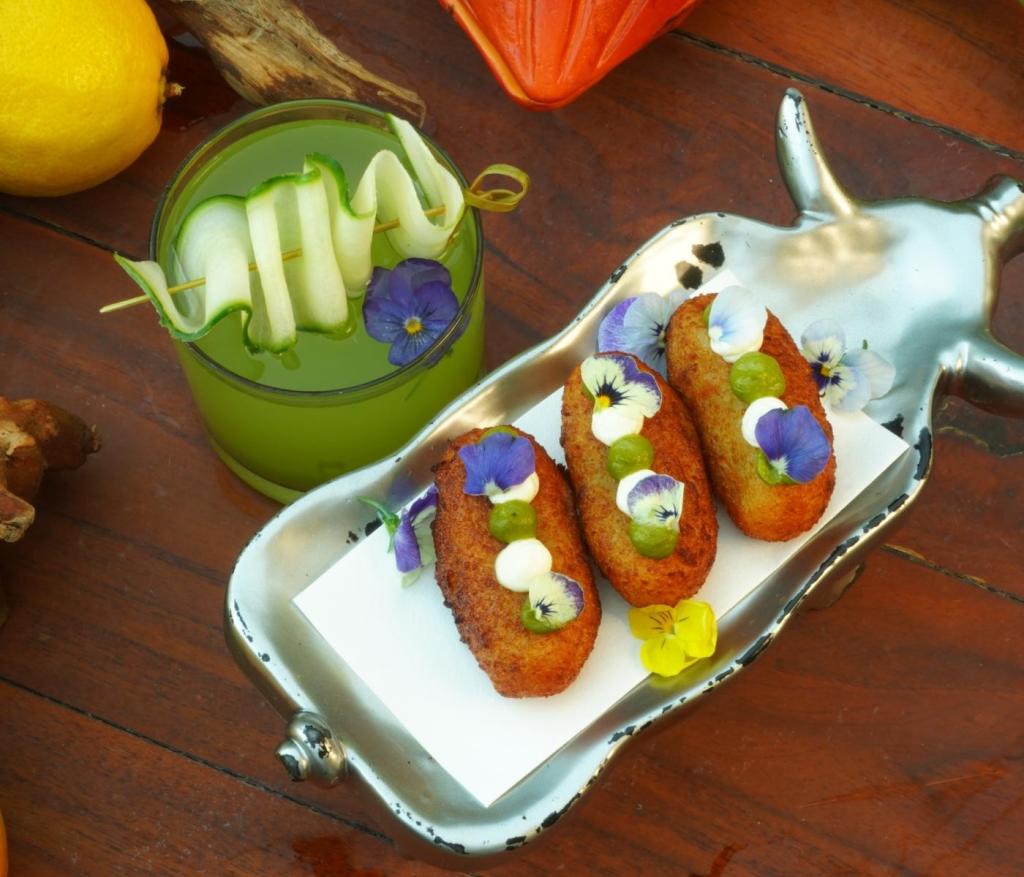 a colorful dish with a green cocktail 