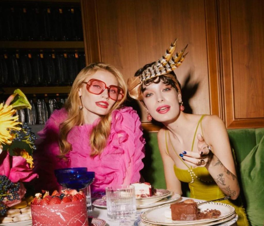 Two female models sit together in front of dessert for Taste of SLS South Beach