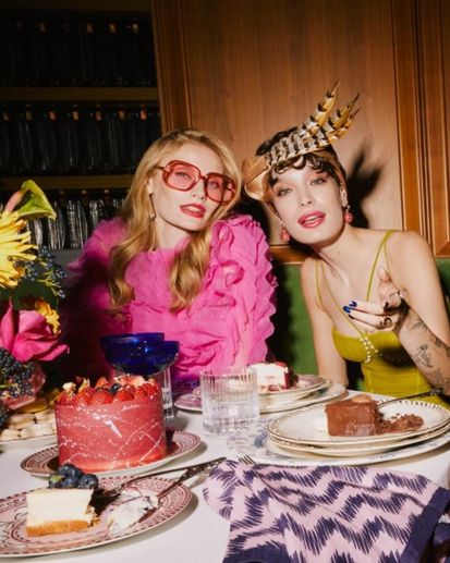 Two female models sit together in front of dessert for Taste of SLS South Beach