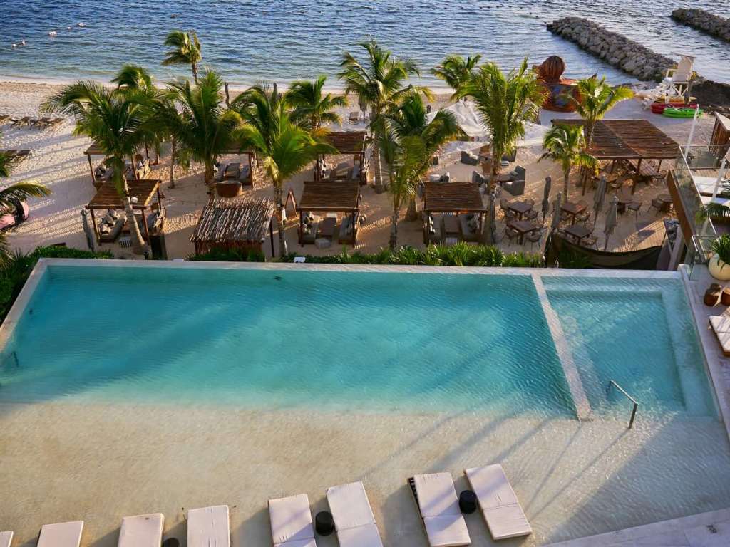 an overhead shot of the pool and beach at sls cancun