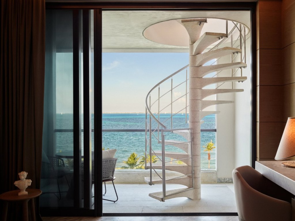 a spiral staircase on a patio in a suite at sls playa mujeres