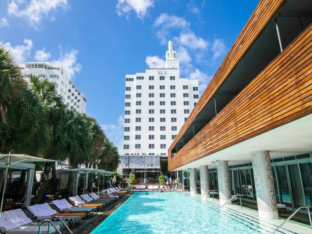 a view of the pool at sls south beach with the iconic tower in the background