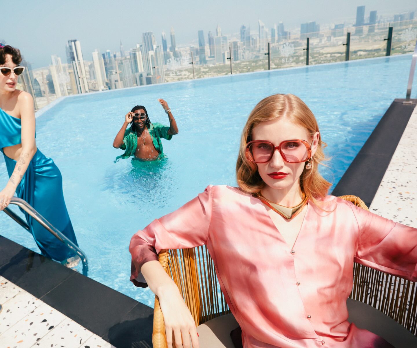 an image of three elegantly dressed individuals in a pool 