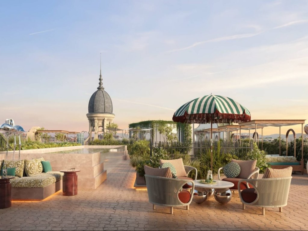 a beautiful rooftop terrace with luxurious furniture overlooking a duomo