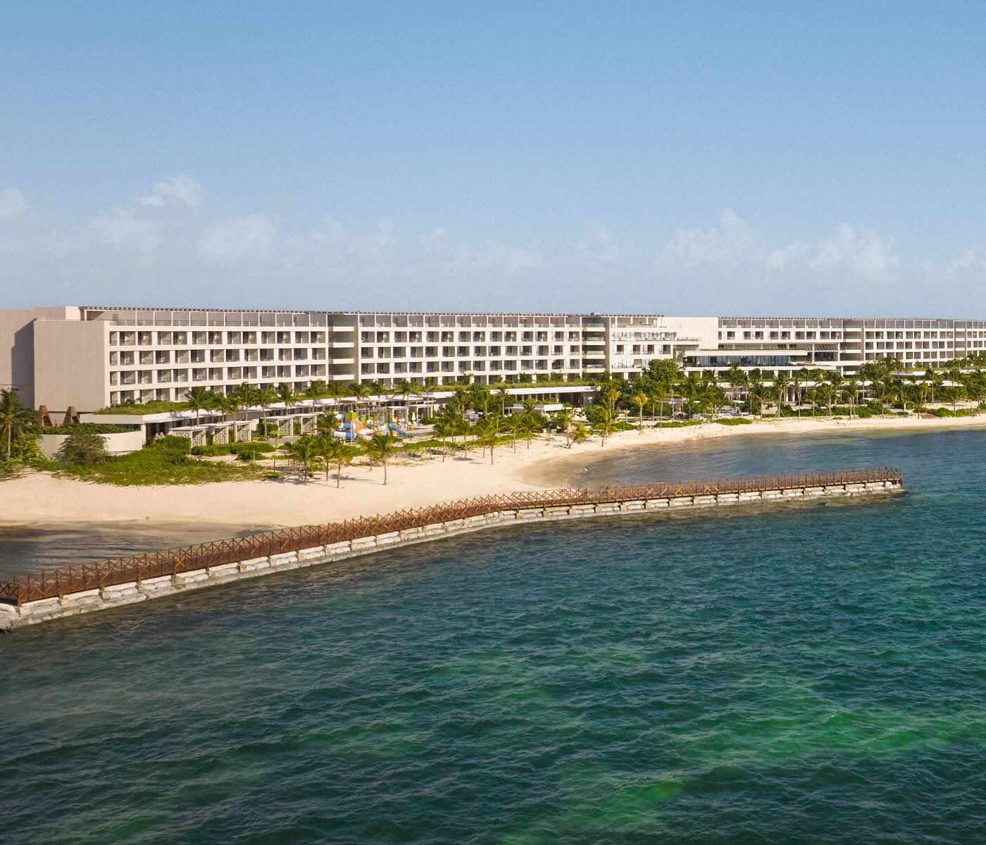 an aerial view of sls playa mujeres, a beachside all-inclusive resort