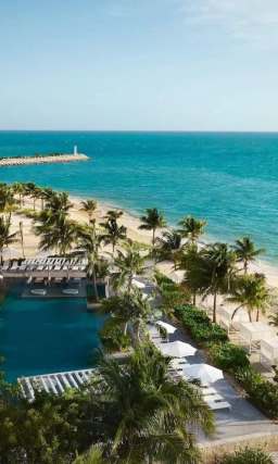 an aerial view of the beach and one of four pools at SLS playa mujeres