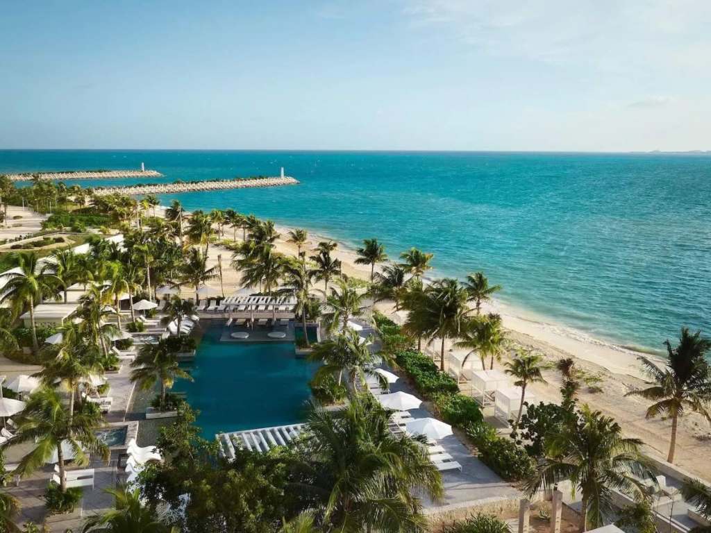 an aerial view of the beach and one of four pools at SLS playa mujeres