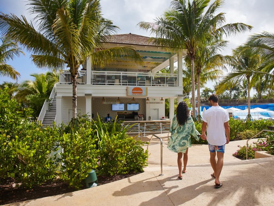 two guests walking into umami burger at baha bay