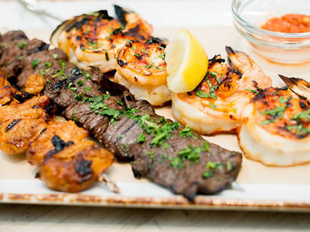 A beautiful array of chicken, beef and shrimp shish kabobs.