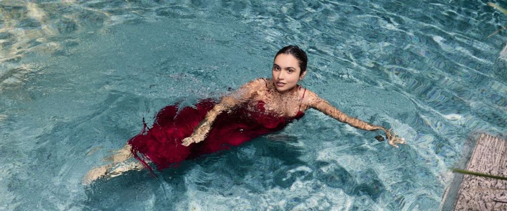 woman in an elegant red dress in a swimming pool