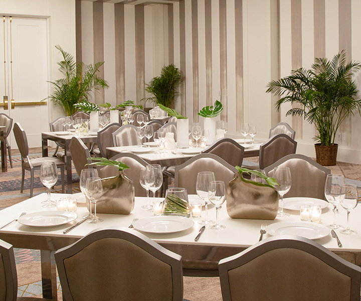 Tables and chairs arranged in a large room for meetings and celebrations