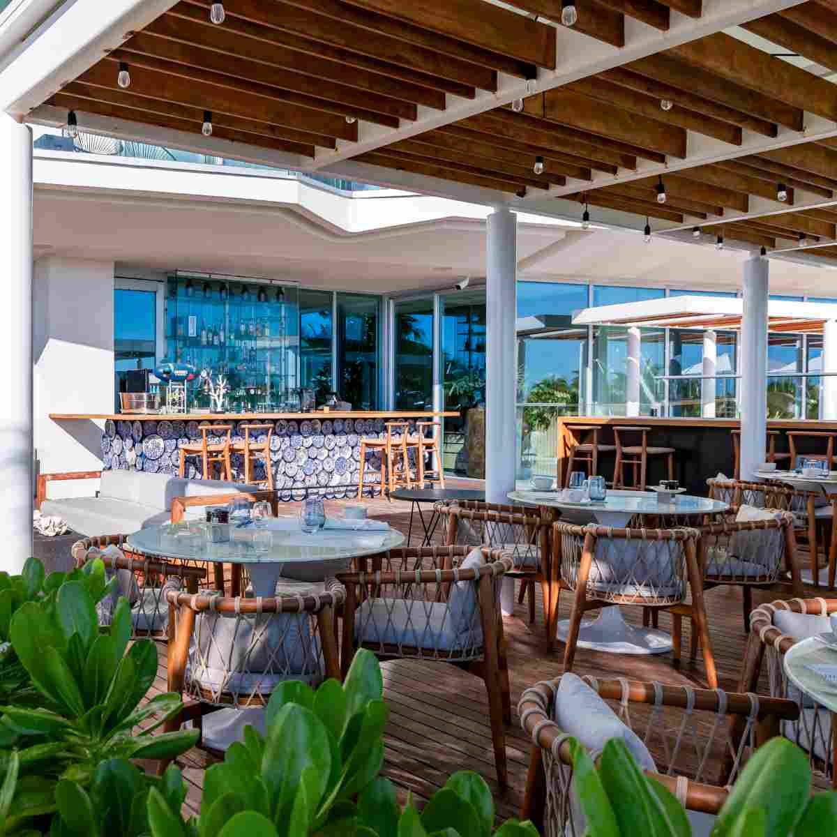 spacious outdoor dining patio with tables and chairs