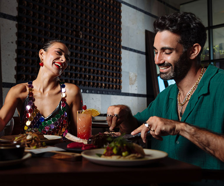 A couple laughing over dinner