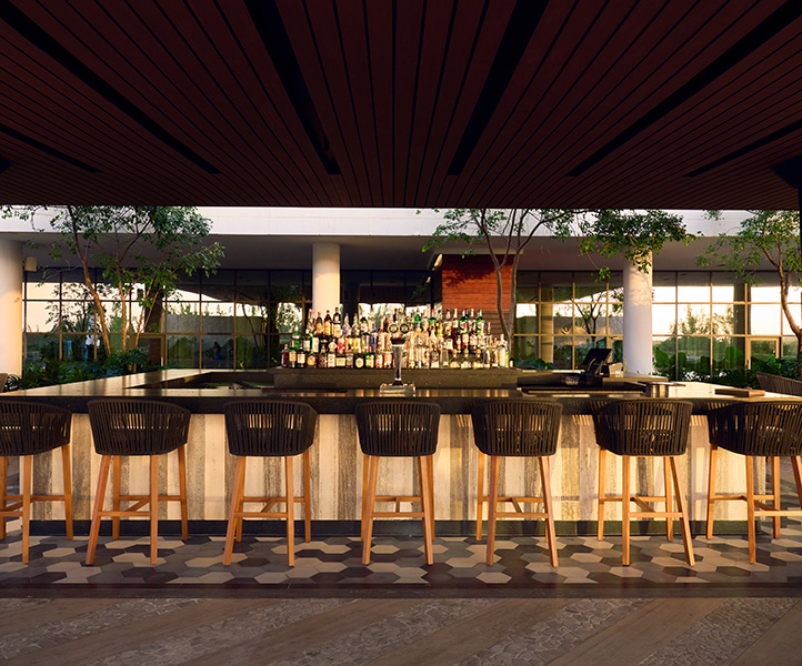 Outdoor bar with seats at SLS Playa Mujeres