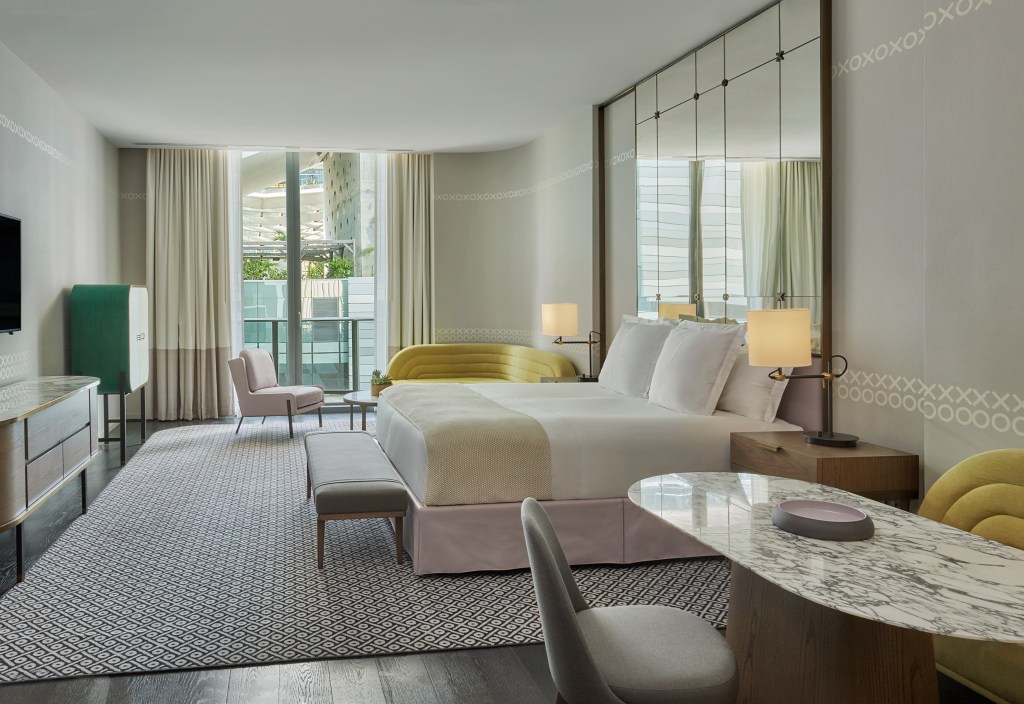 spacious suite with large bed and city view